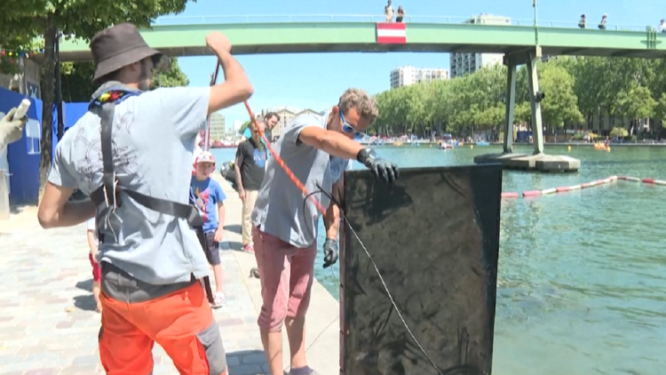 Divers retrieve bicycles and televisions from a canal in the middle of Paris