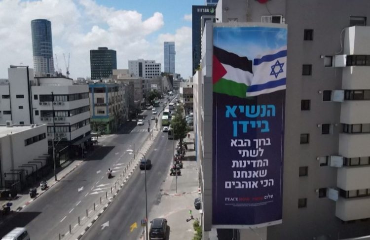 Israeli anti-occupation group’s banner rises in Tel Aviv ahead of Biden’s visit (photos)